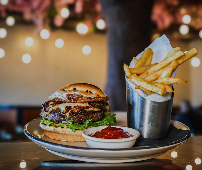Specialty burger and fries plate at Coca Bar and Lounge in Bethpage